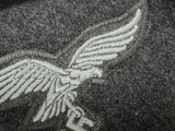 detail of the pre-sewn eagle with blue-grey thread.